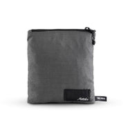packed up charcoal poncho on white background