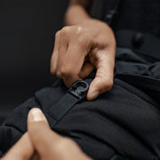 Close up view of hands holding the magnetic latch closure